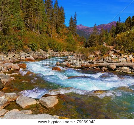 Pastoral in the Alpine mountain valley in Austria. Cascades of cold water at the source of the famous Krimml waterfalls. 