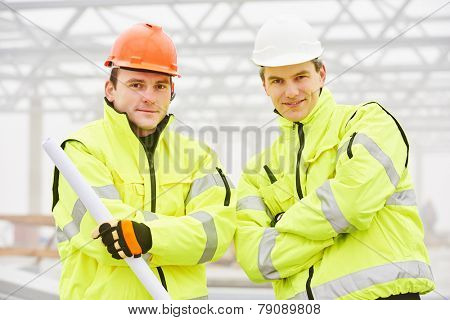 male engineers construction foreman managers outdoors indoors at building site with blueprints