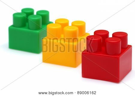 Red Lego Piece In Focus, Green And Yellow Not In Focus