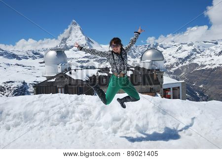 Young girl jump on the background Matterhorn