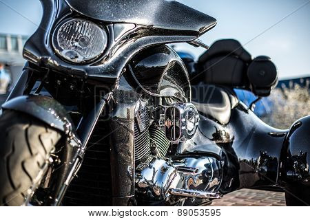 Black trike standing on the light street