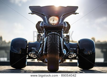 Black trike standing on the light street