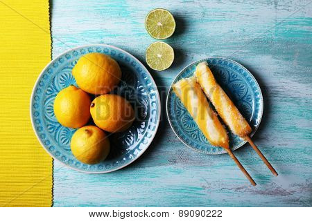 Lemons and ice cream on plates on table top view