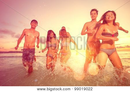 Group of young people having fun on beach, joyful and smiling  teens