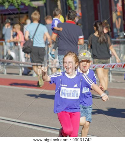 Happy Young Girl And Boy Running