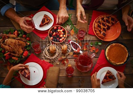 People eating a pie and drinking cranberry compote