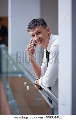 business man using phone at modern office space