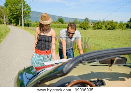 a couple, on vacation, look at a map, on the raod