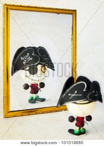 Toy  pirate looking in the mirror