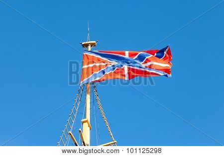 Serf Russian Navy Flag On The Flagpole Against Blue Sky