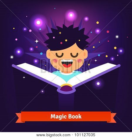 Boy kid reading magic spell book as it glows