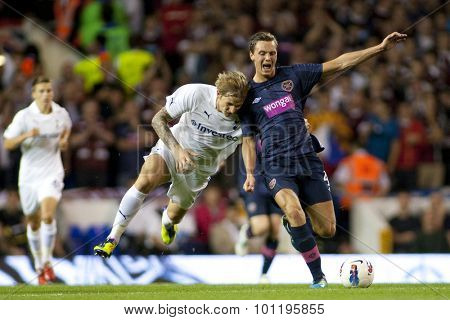 LONDON ENGLAND 25 August 2011. Tottenham's Roman Pavlyuchenko appears to rugby tackle Hearts player Eggert JÃ?ÃÂ¢hnsson during the UEFA Europa league match between Tottenham Hotspurs  and Hearts. 