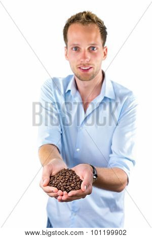 Young Salesman Showing Hands Full With Coffee Beans
