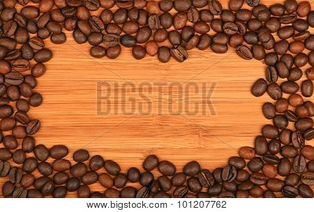 Coffee Beans Border Frame Over Bamboo Wood Background
