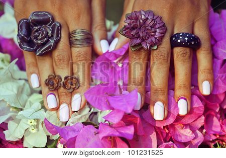 bright colorfull shot of african tanned hands with manicure amon