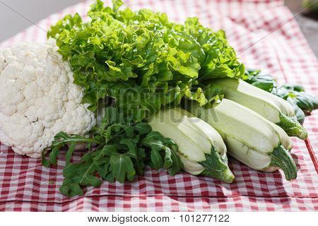 Lettuce, Arugula, Zucchini And Cauliflower On A Cloth