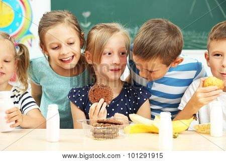Cute children at lunch time in classroom