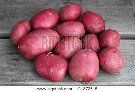 New Red Potetoes On The Old Board Surface