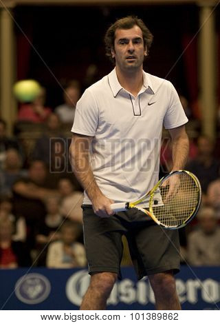 LONDON, ENGLAND. 05 DECEMBER 2009 -   Cedric Pioline (FRA) watches the ball fly past him while competing in the season finale to the ATP Champions Tour match during the AEGON Masters Tennis
