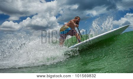 A surfer throws a huge plume of spray as he executes a radical cutback