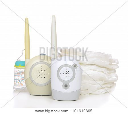 Child Baby Kid Radio Monitor Device Stack Of Diapers With Baby Feeding Bottle Water