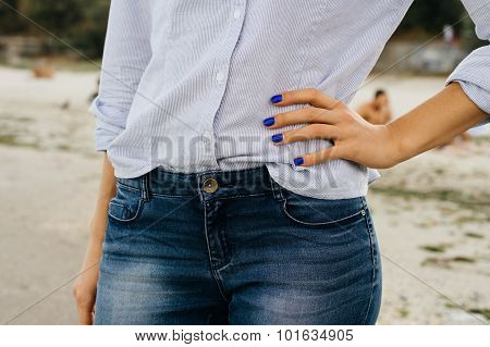 Woman In Jeans And Shirt Standing On The Beach