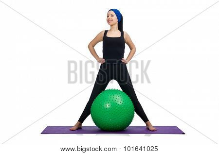 Young woman exercising with swiss ball