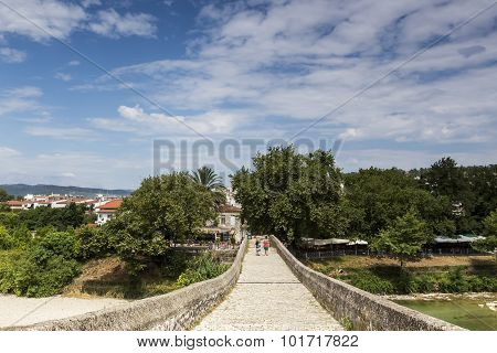 Women Walking On The Bridge Looking At The View Of Arachthos River Of Arta City, Epirus Greece