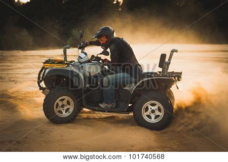 Racing ATV is sand.