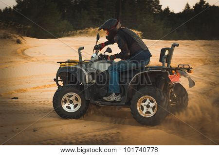 Racing ATV is sand.