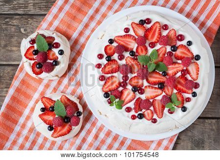 Gourmet homemade traditional Pavlova meringue sweet desset party cake with whipped cream, strawberry