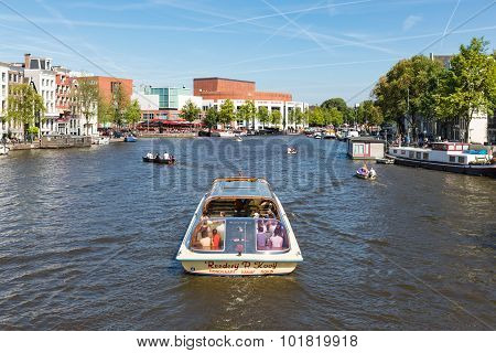 Canal With Recreating People In A Cruise Ship In Amsterdam