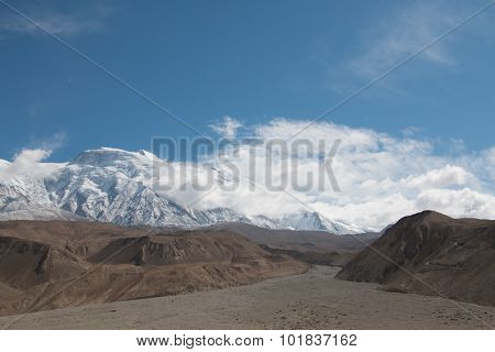 Empty Riverbed With Snow Mountain