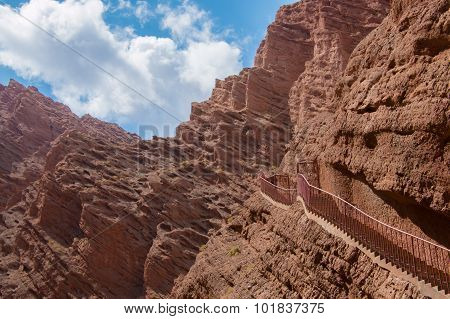Stairs Attached To Red Mountain Leading To The Sky