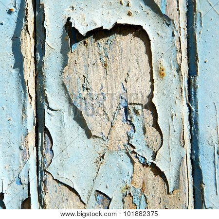 Stripped Paint In The Blue Wood Door And Rusty Nail