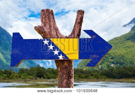 Bosnia and Herzegovina Flag wooden sign with landscape on background