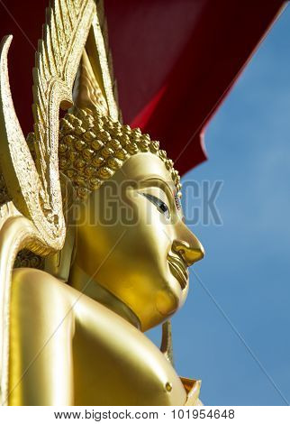 Golden Buddha In Thai Style Statue With Clear Blue Sky