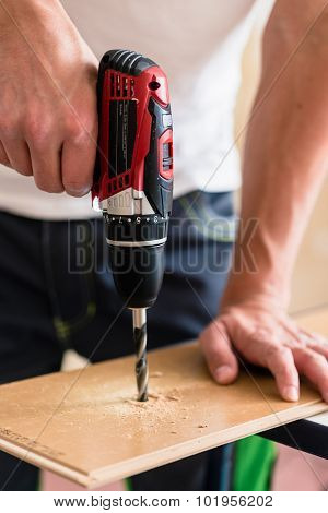 Craftsman or DIY man working with power drill