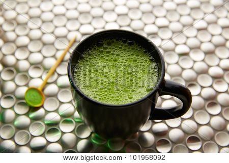 Matcha green tea from Japan on modern stainless steel background
