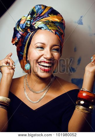 beauty bright african woman with creative make up, shawl on head like cubian closeup