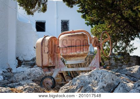 Orange cement mixer on a construction site