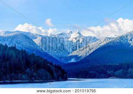 Snow Mountains and Capilano Lake in Vancouver British Columbia Pacific Northwest.
