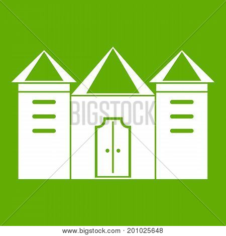 Wall and gate of the old fortress icon white isolated on green background. Vector illustration