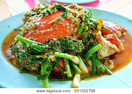 Crab meat with yellow curry powder on plate.