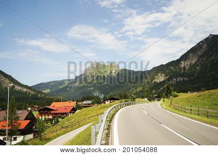 Road in the Tyrolean Alps in the direction of the mountain Aggenstein