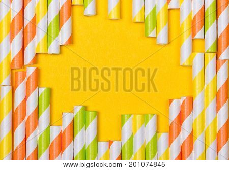 close-up colorful fancy drinking straws fancy tube for party on the yellow background