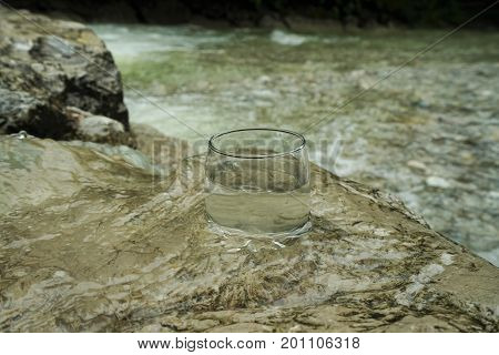 Water glass in a clear mountain stream