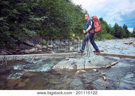 Hiking in the mountains with a backpack in the summer.