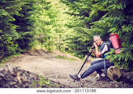 Hiking in the mountains with a backpack in the summer.