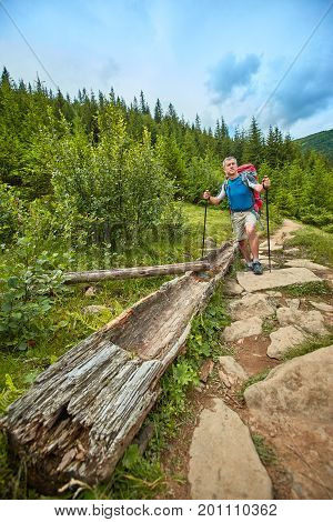 Hiking in the mountains with a backpack in the summer.